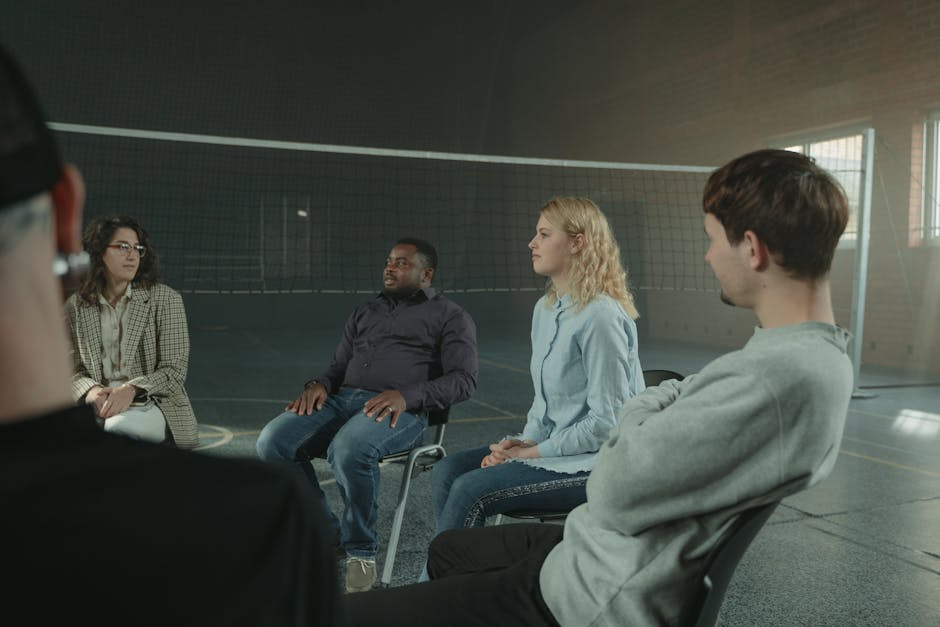 A group of young people in conversation at a community event.